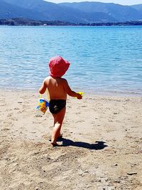 Full length of girl playing on beach