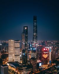 Illuminated cityscape against sky at night