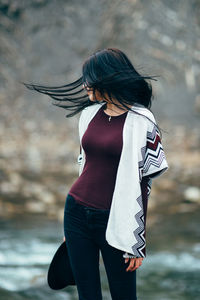 Midsection of woman standing in water