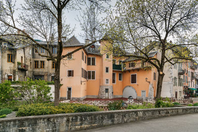 Houses by street in town against sky