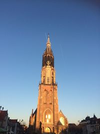 Low angle view of clock tower against blue sky