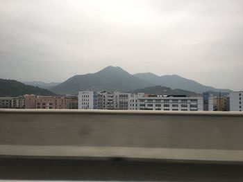 High angle view of buildings in city against sky