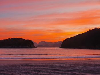 Scenic view of silhouette mountains against sky during sunset