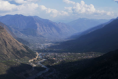 Scenic view of valley and mountains against sky