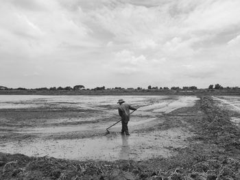 Man standing on beach against sky