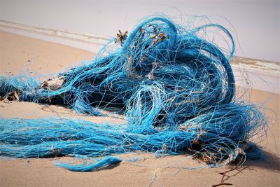 Close-up of fishing net on beach
