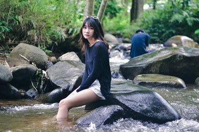 Portrait of young woman exercising in water