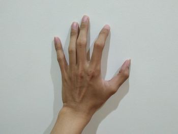 Close-up of hand against white background