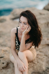 Portrait of woman sitting on beach