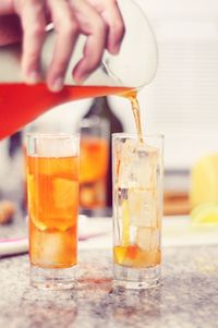 Cropped image of person preparing drink