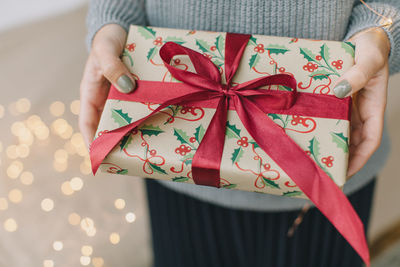 Midsection of woman holding gift