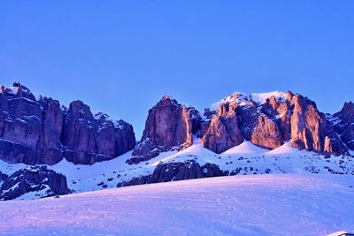 Scenic view of snow covered mountains against clear sky