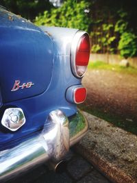 Close-up of vintage car on road