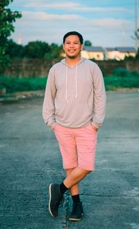 Portrait of smiling man standing on shore