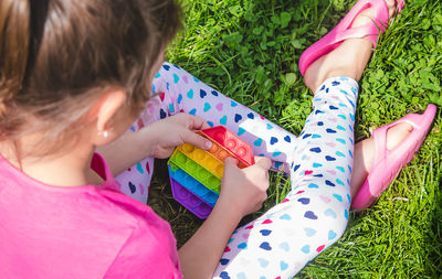 High angle view of girl playing with toys on field