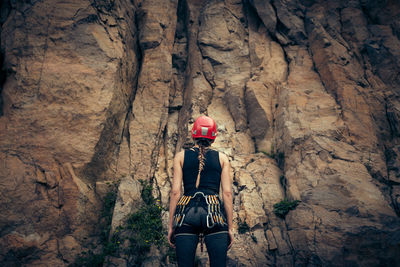 Rear view of person standing on rock