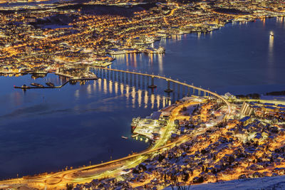 Norway, troms og finnmark, tromso, long exposure of illuminated city seen from fjellheisen at dusk