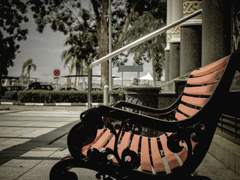 Empty benches on footpath in city