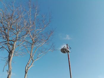 Low angle view of street light against clear blue sky