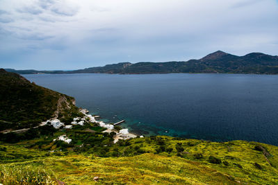 Scenic view of sea and mountains against sky