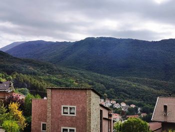 Houses and mountains against sky