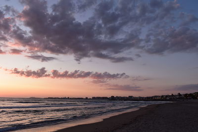 Scenic view of beach against sky during sunset