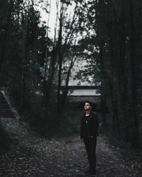 Portrait of woman standing in forest