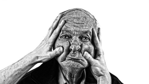Close-up portrait of man against white background