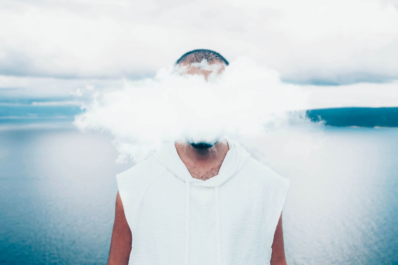 Conceptual portrait of man with head in the clouds