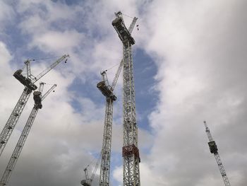 Low angle view of cranes against sky