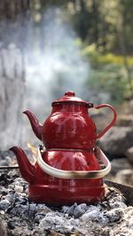 Close-up of kettle with teapot on campfire