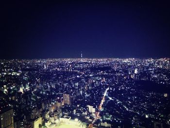 High angle view of city lit up at night