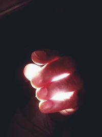 Close-up of hand holding illuminated lights