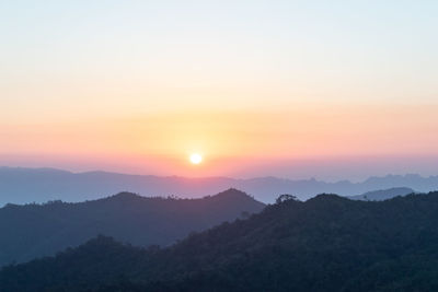 Scenic view of silhouette mountains against sky during sunset
