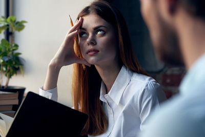 Portrait of young woman using mobile phone