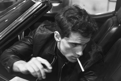 Close-up of young man smoking cigarette
