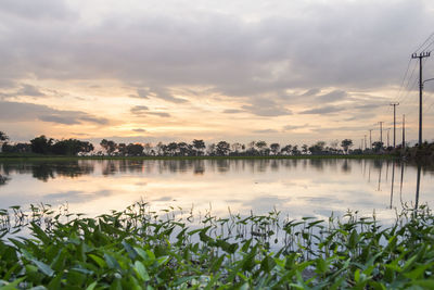 Scenic view of lake against sky during sunset