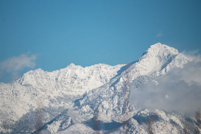 Scenic view of snowcapped mountains against clear sky