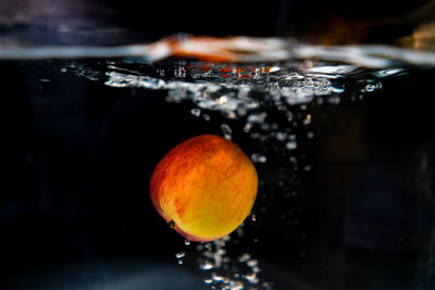 Close-up of lemon in water at night