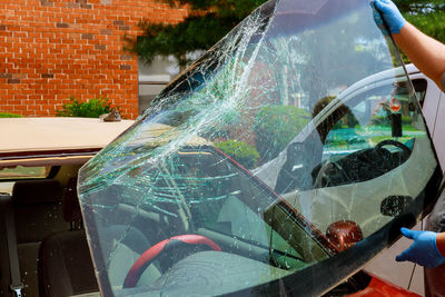 Reflection of woman on glass of car