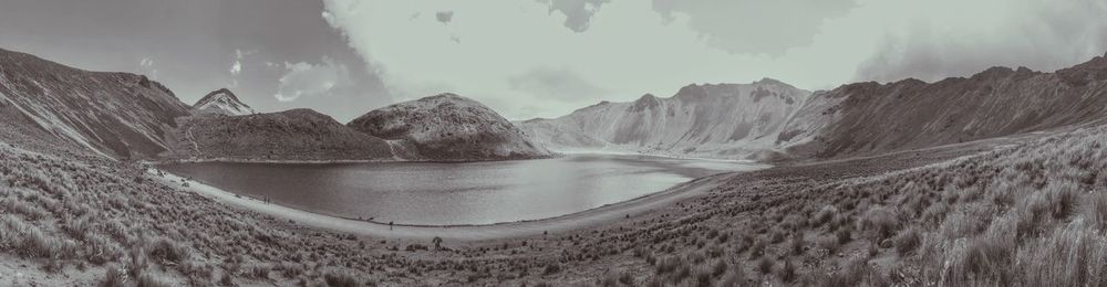 Panoramic view of land and mountains against sky