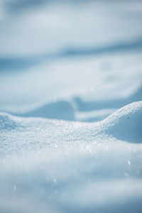 Close-up of snow on land against sky