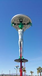 Low angle view of windmill against clear blue sky