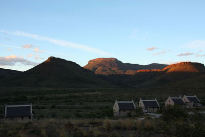 Houses on mountain against sky