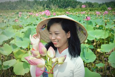 Close-up of happy girl standing against plants