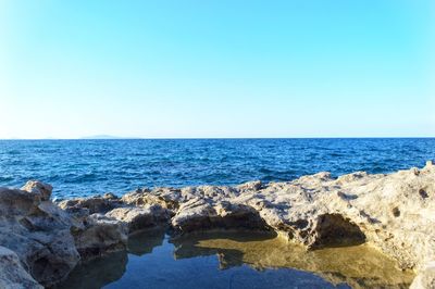 Scenic view of sea against clear blue sky