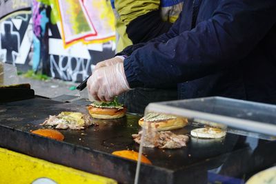 Man preparing food at market stall