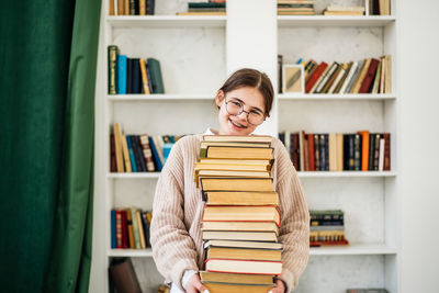Portrait of young woman reading book