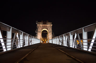 Illuminated tunnel at night