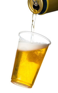 Close-up of beer glass against white background